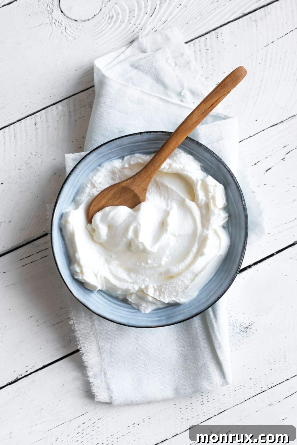 Bowl of Greek yogurt on white towel.