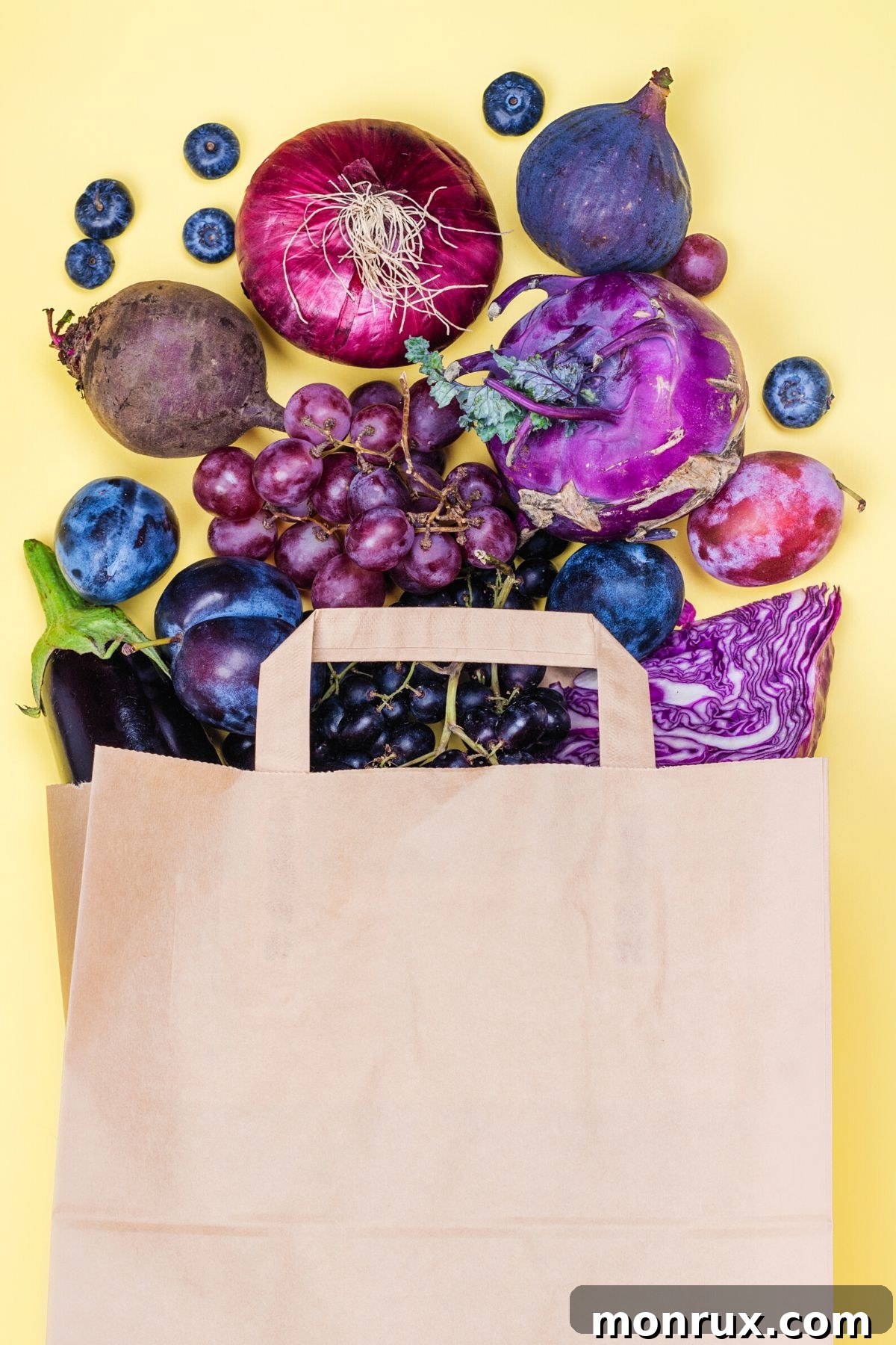A vibrant assortment of blue and purple fruits and vegetables overflowing from a rustic paper bag, showcasing nature's unique color palette.