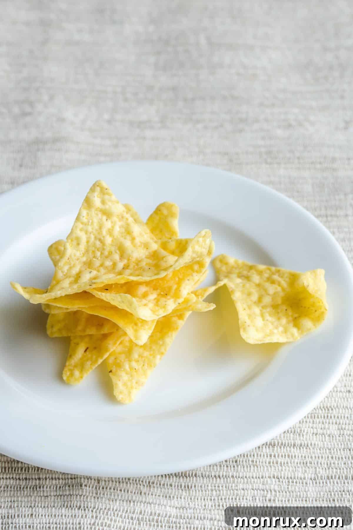 Plate with stack of yellow corn chips.