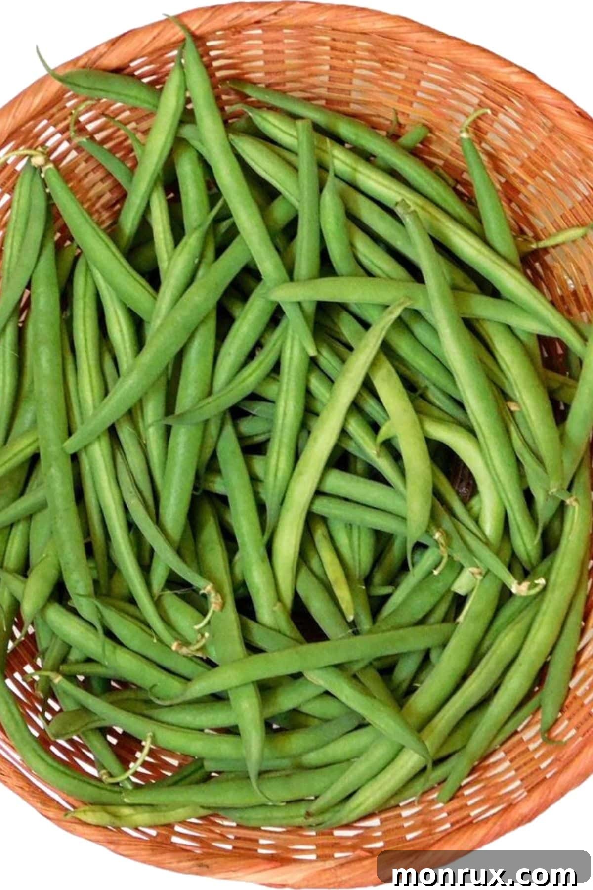 A basket filled with fresh green beans.