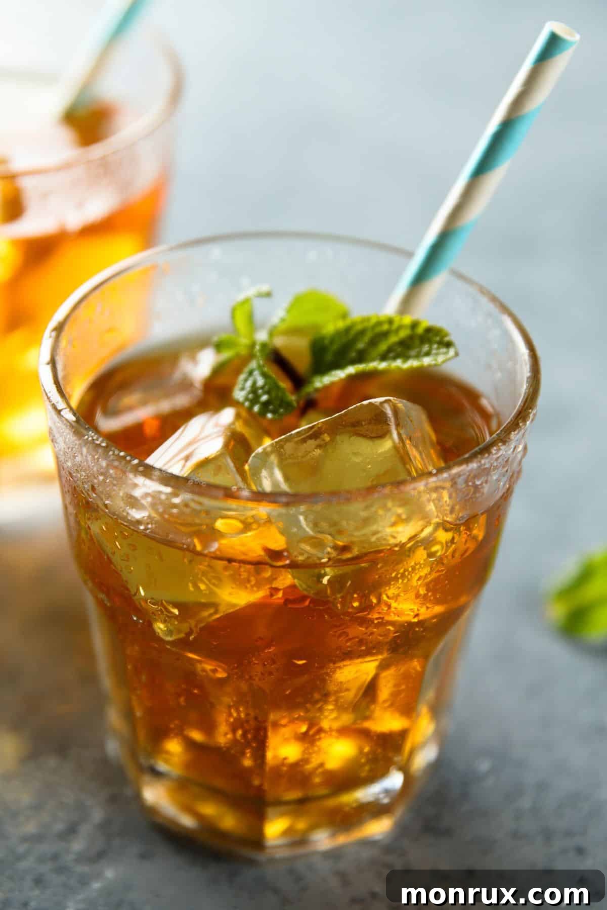 iced mint tea in a glass with a straw.