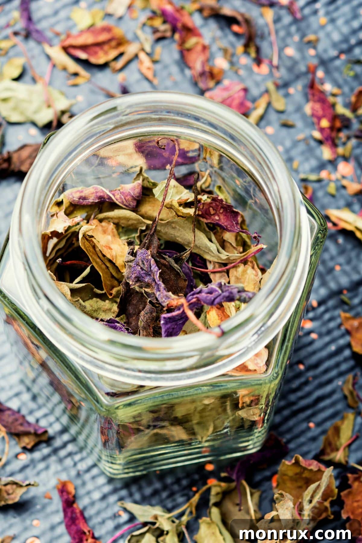 whole dried basil leaves in a jar.