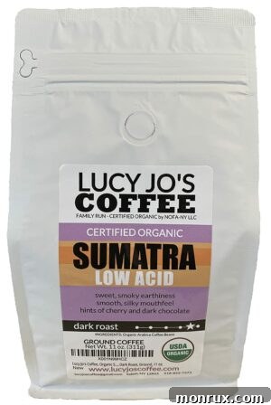 A bag of Lucy Jo's Coffee in Sumatra dark roast, emphasizing its ground form, organic certification, and ethical sourcing.