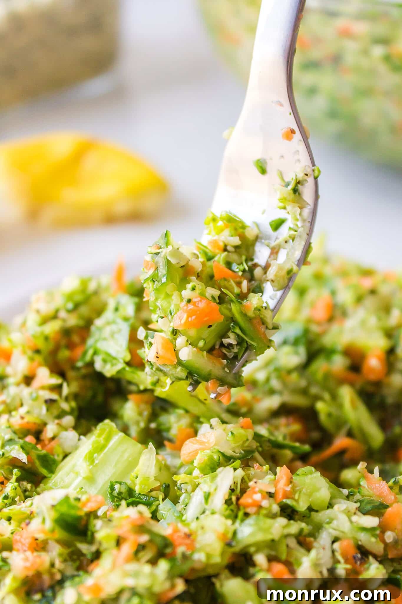A fork with a bite of chopped veggie salad.