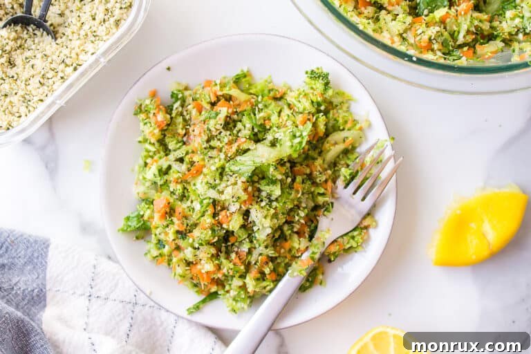 A serving of chopped veggie salad on a small white plate with a fork.