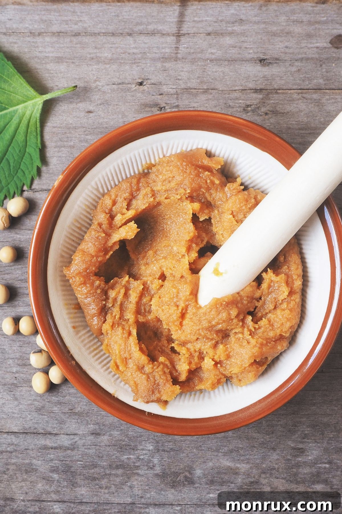 Bowl of white soybean paste on wooden surface.