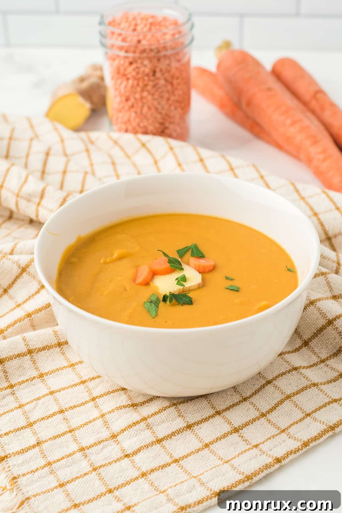 A comforting bowl of vibrant orange ginger soup, perfect for a soft food diet.