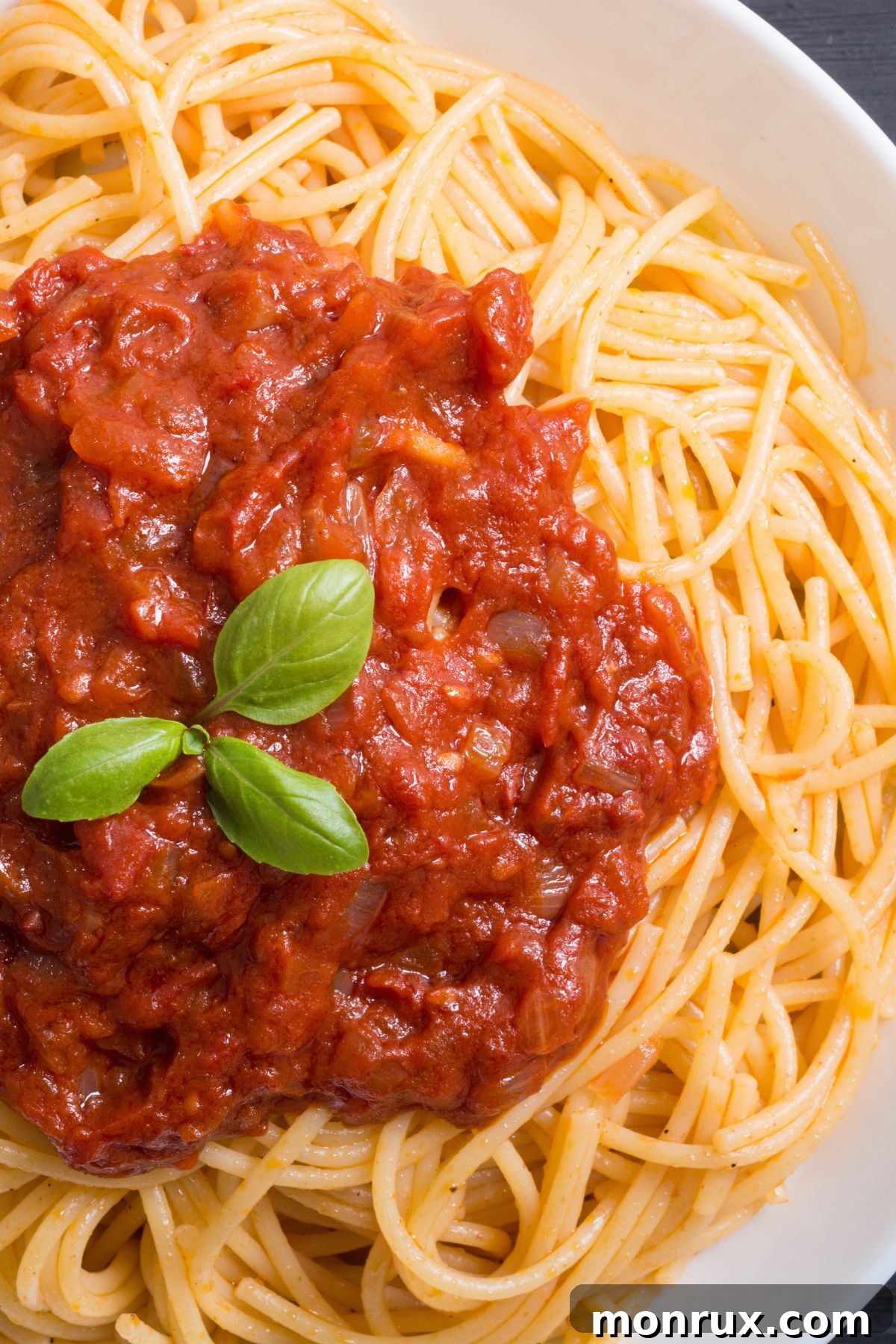 A hearty bowl of spaghetti with marinara sauce, a simple and soft meal option.
