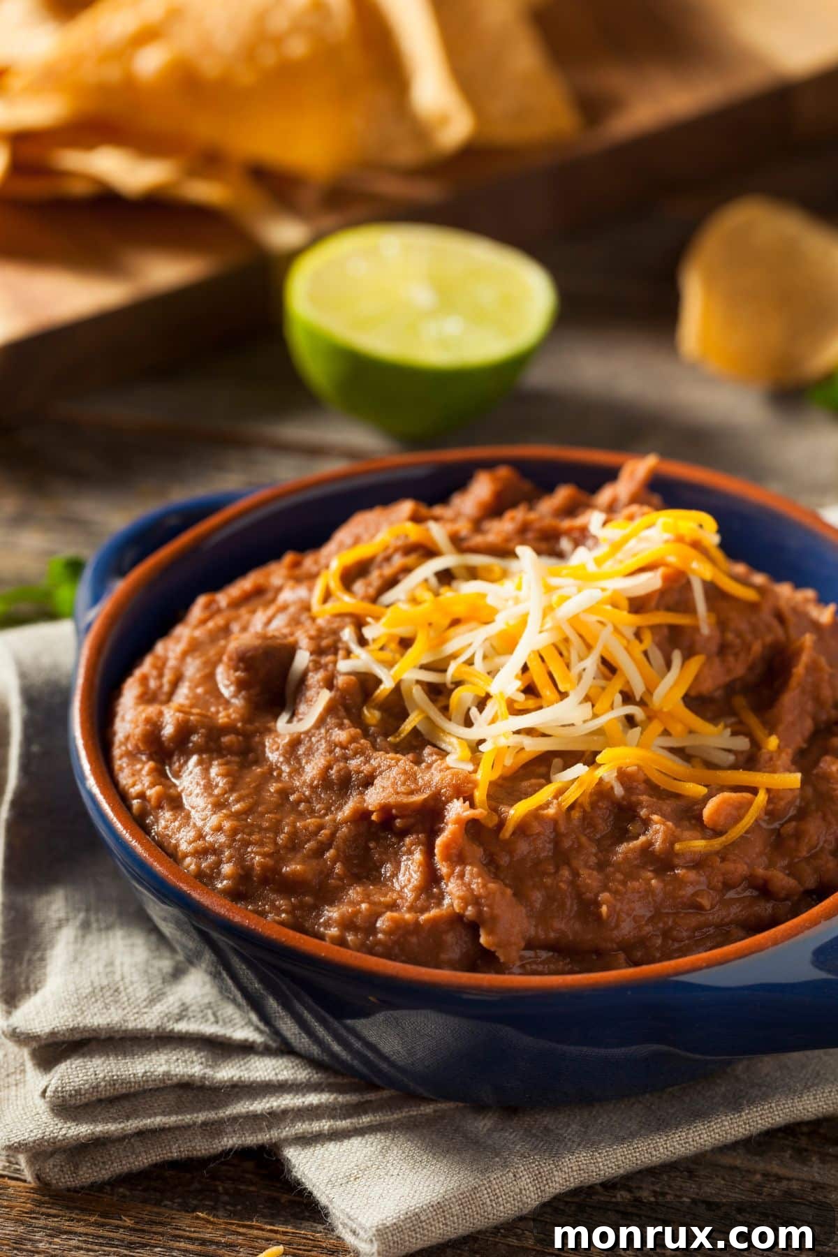 A bowl of creamy refried beans, a hearty and soft vegetarian option.