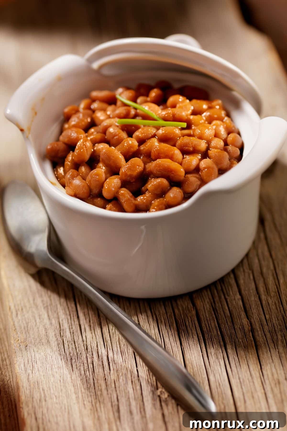A bowl of hearty baked beans, a satisfying and soft meal option.
