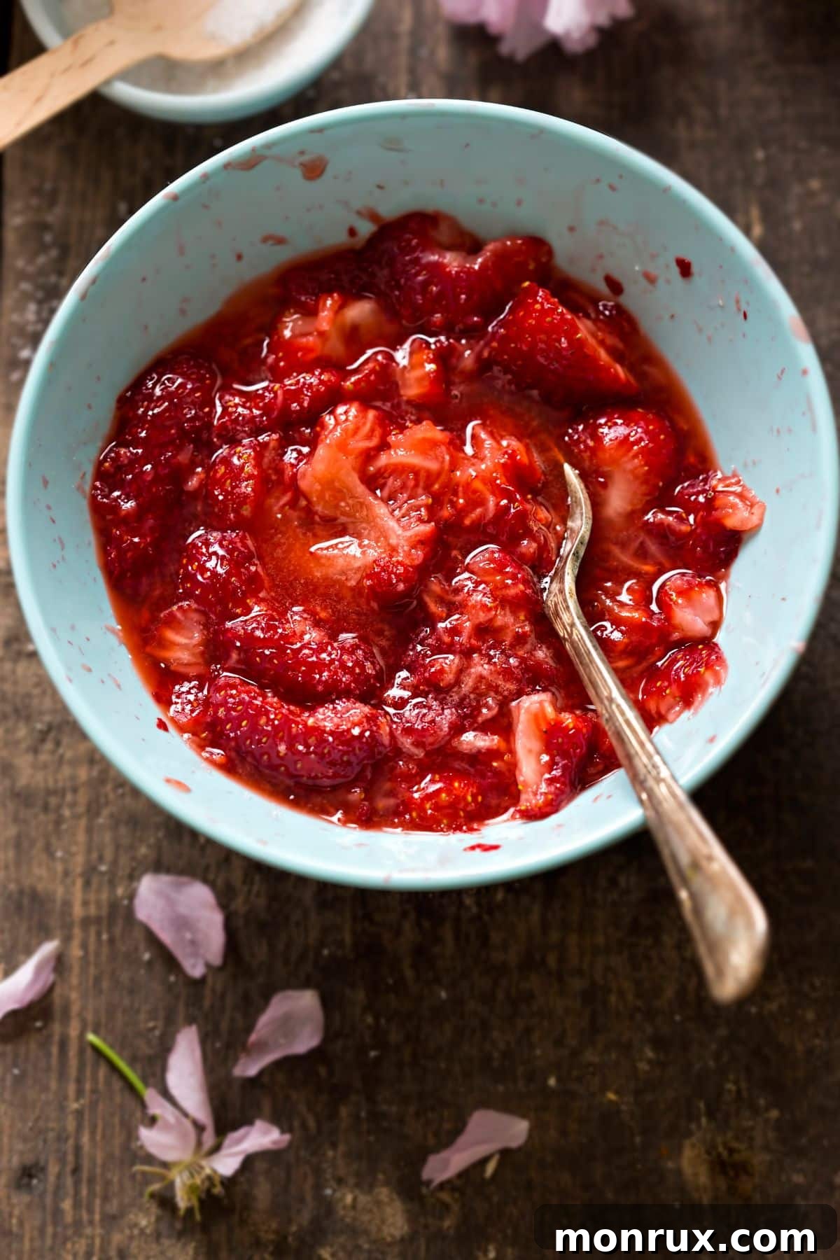 A bowl of mashed strawberries, a simple and delicious fruit puree.