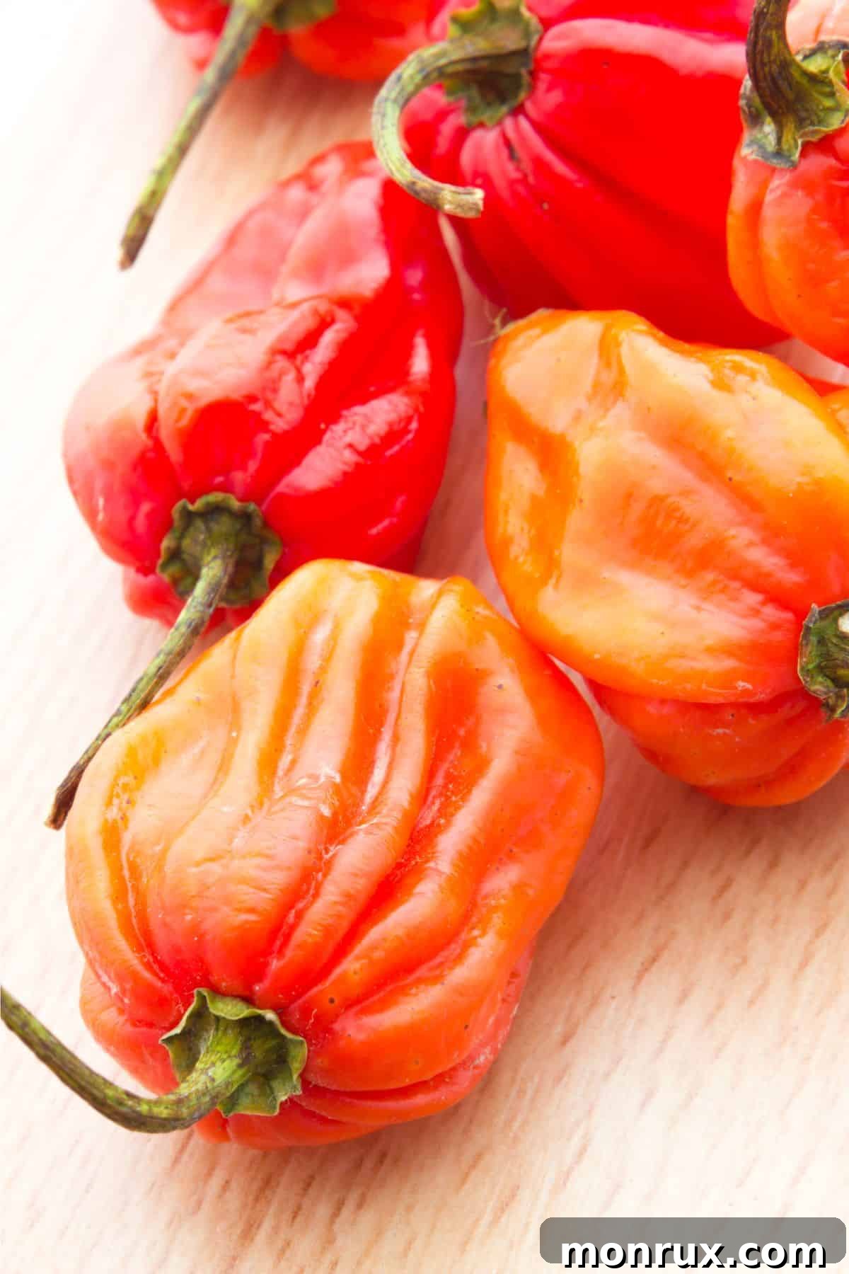 Habanero peppers on wooden surface.