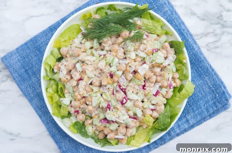 Close-up of a bowl of vegan chickpea tuna salad, garnished and ready to serve.