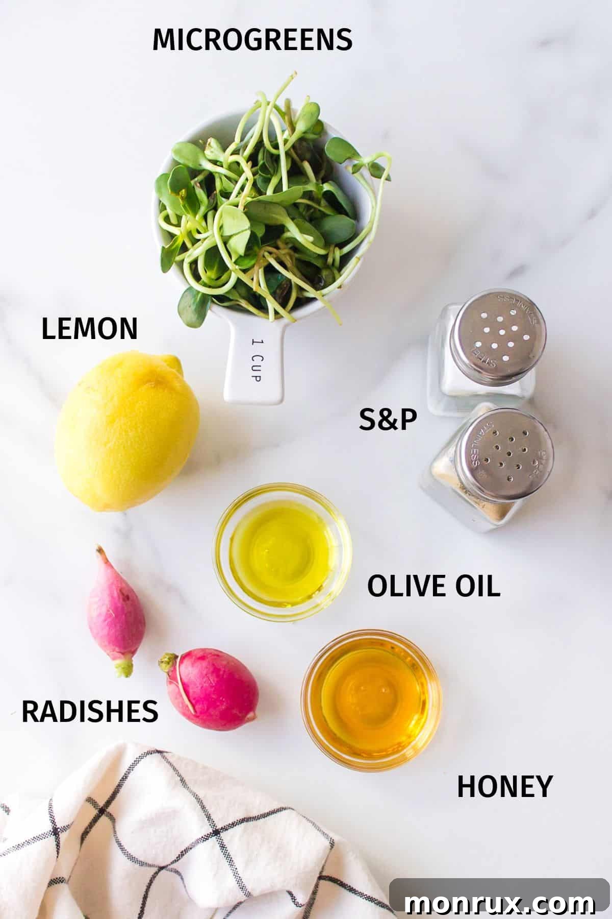 A collection of fresh ingredients for microgreens salad, including microgreens, radishes, olive oil, lemon, and honey, neatly arranged in small bowls.