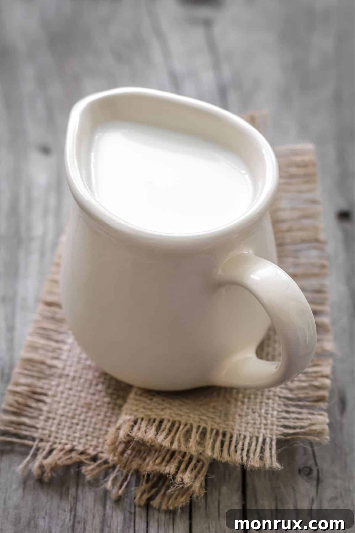Pitcher of cream on a table, illustrating dairy products.