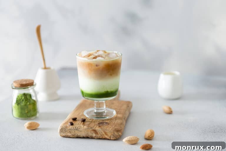 A layered matcha green tea iced espresso on a wooden board, ready to be enjoyed.