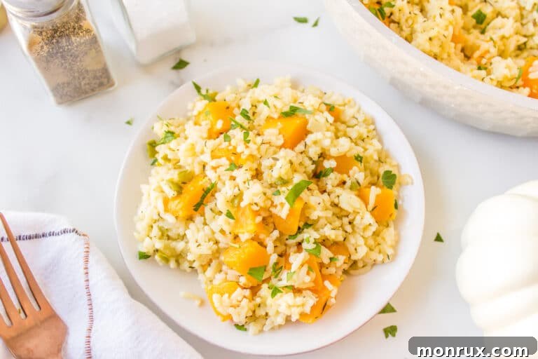 A small white plate filled with a delicious serving of Jamaican pumpkin rice, garnished with fresh herbs.