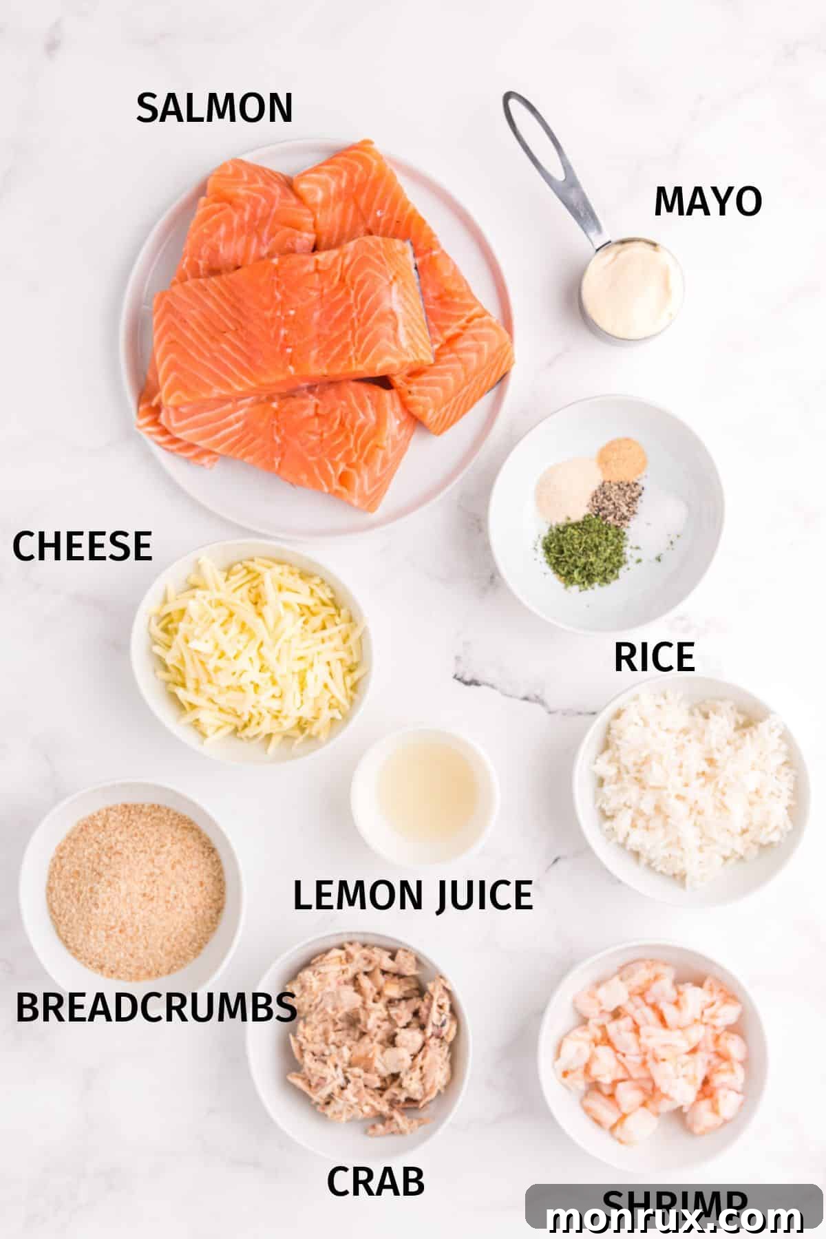 A collection of ingredients artfully arranged in small bowls on a clean white surface, showcasing the components needed to make homemade Costco stuffed salmon.