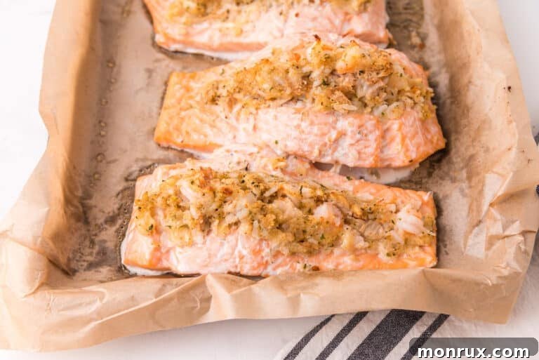 Closeup of a perfectly cooked crab and shrimp stuffed salmon fillet, showcasing the golden crust and succulent filling.