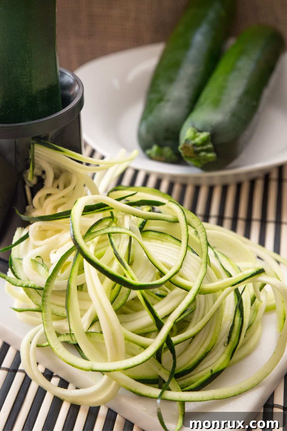 Spiralized zucchini in a pile on a counter, ready for freezing.
