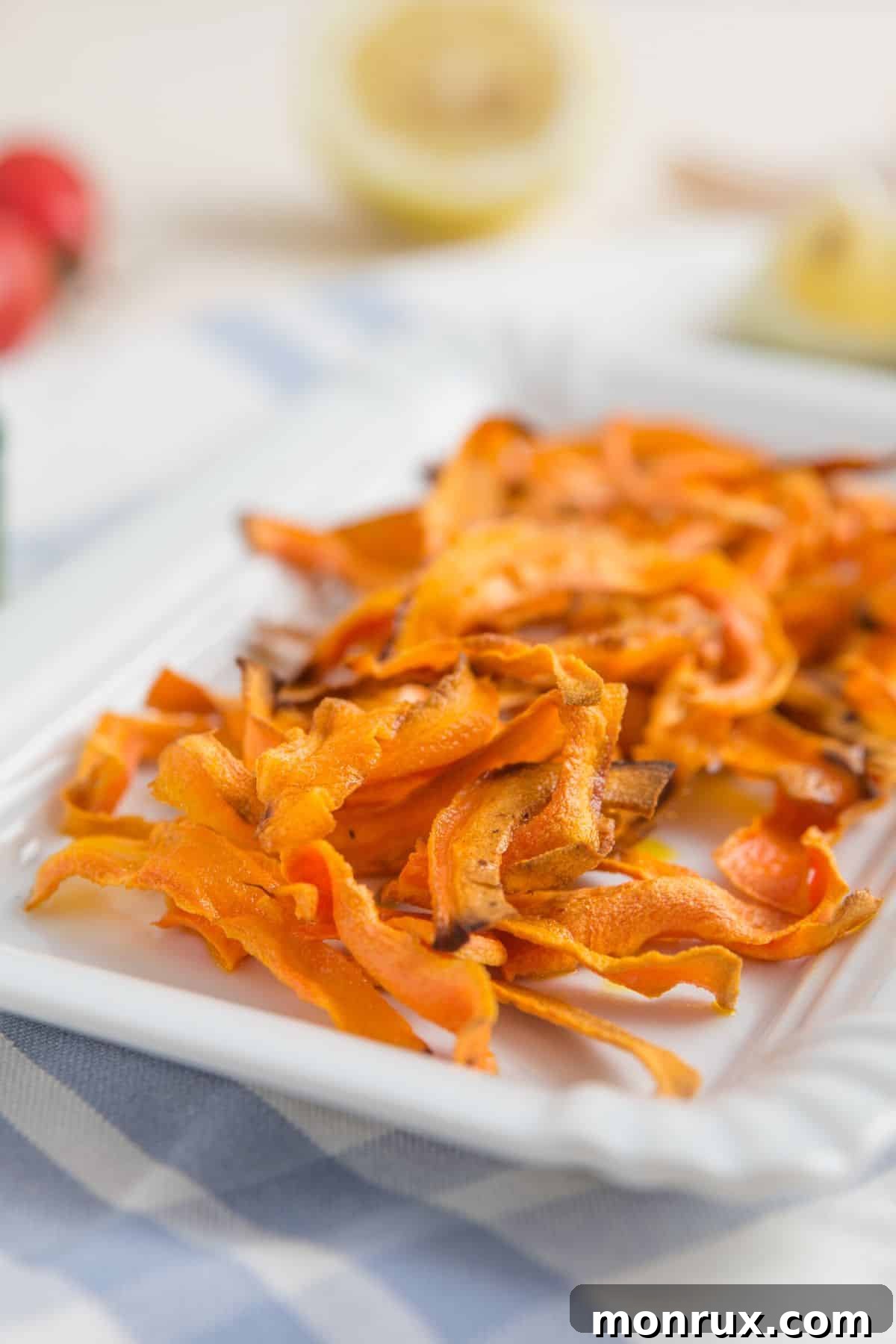 Crispy dehydrated carrot strips neatly arranged on a plate.