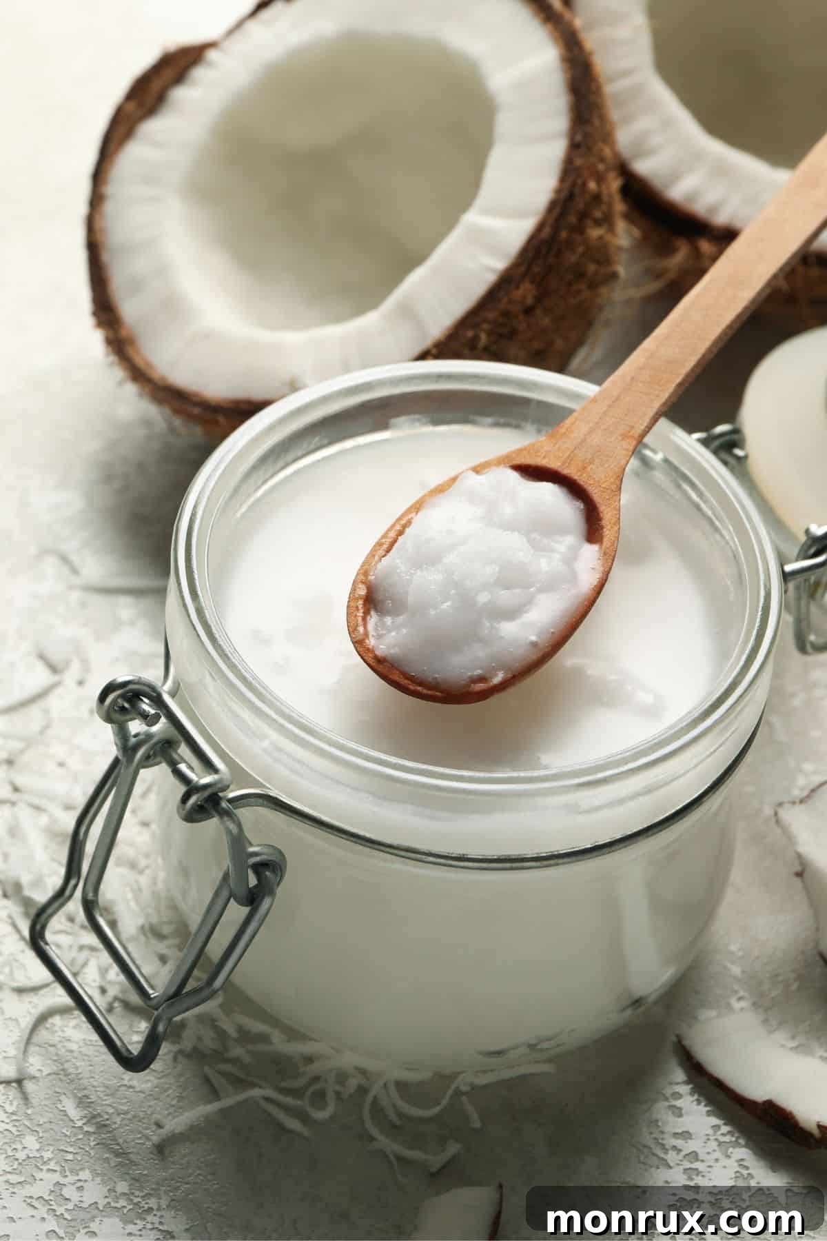 Jar of coconut cream with halved and shredded coconut.