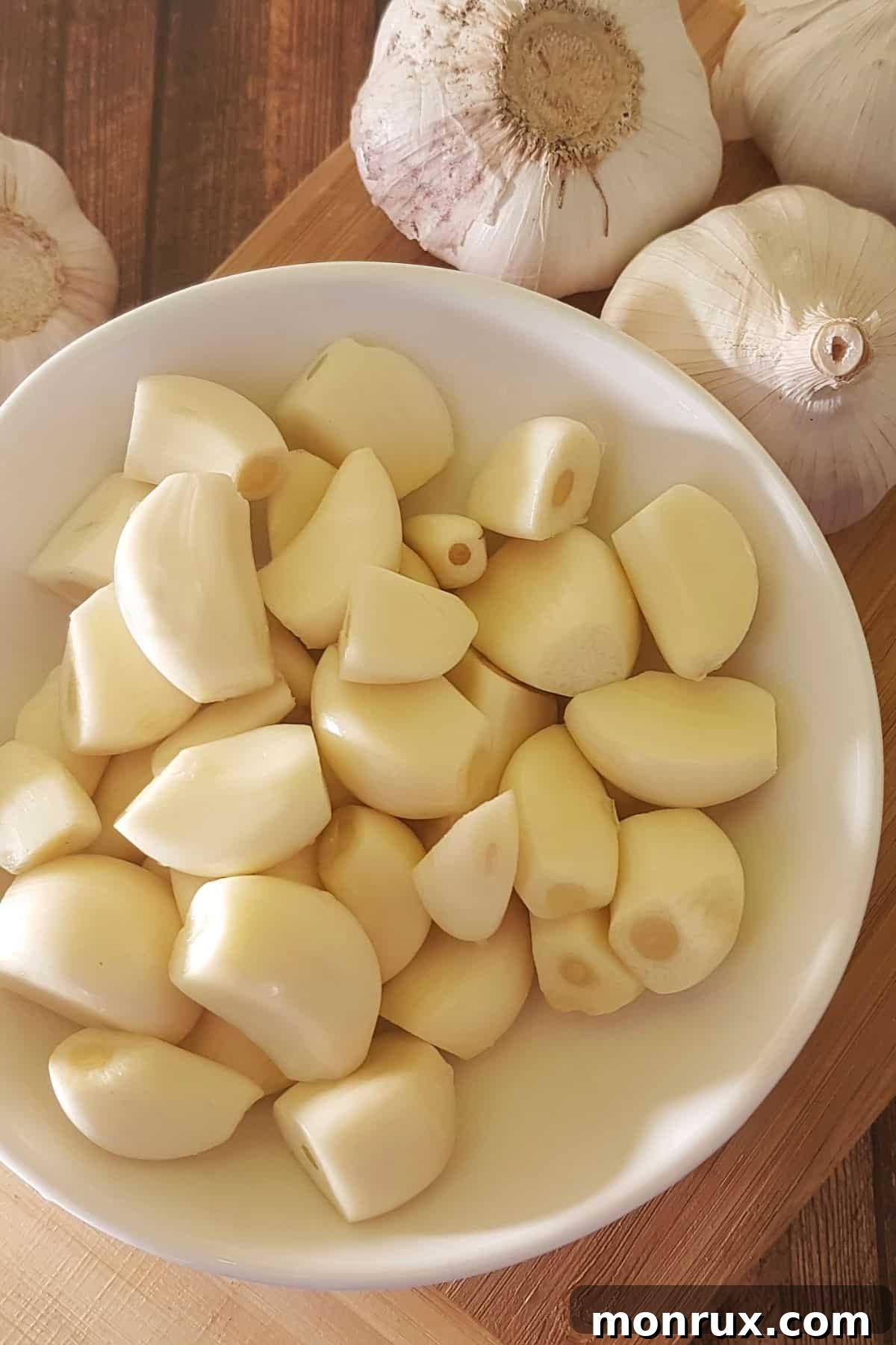 A rustic bowl filled with whole garlic bulbs, a symbol of natural health and liver support.