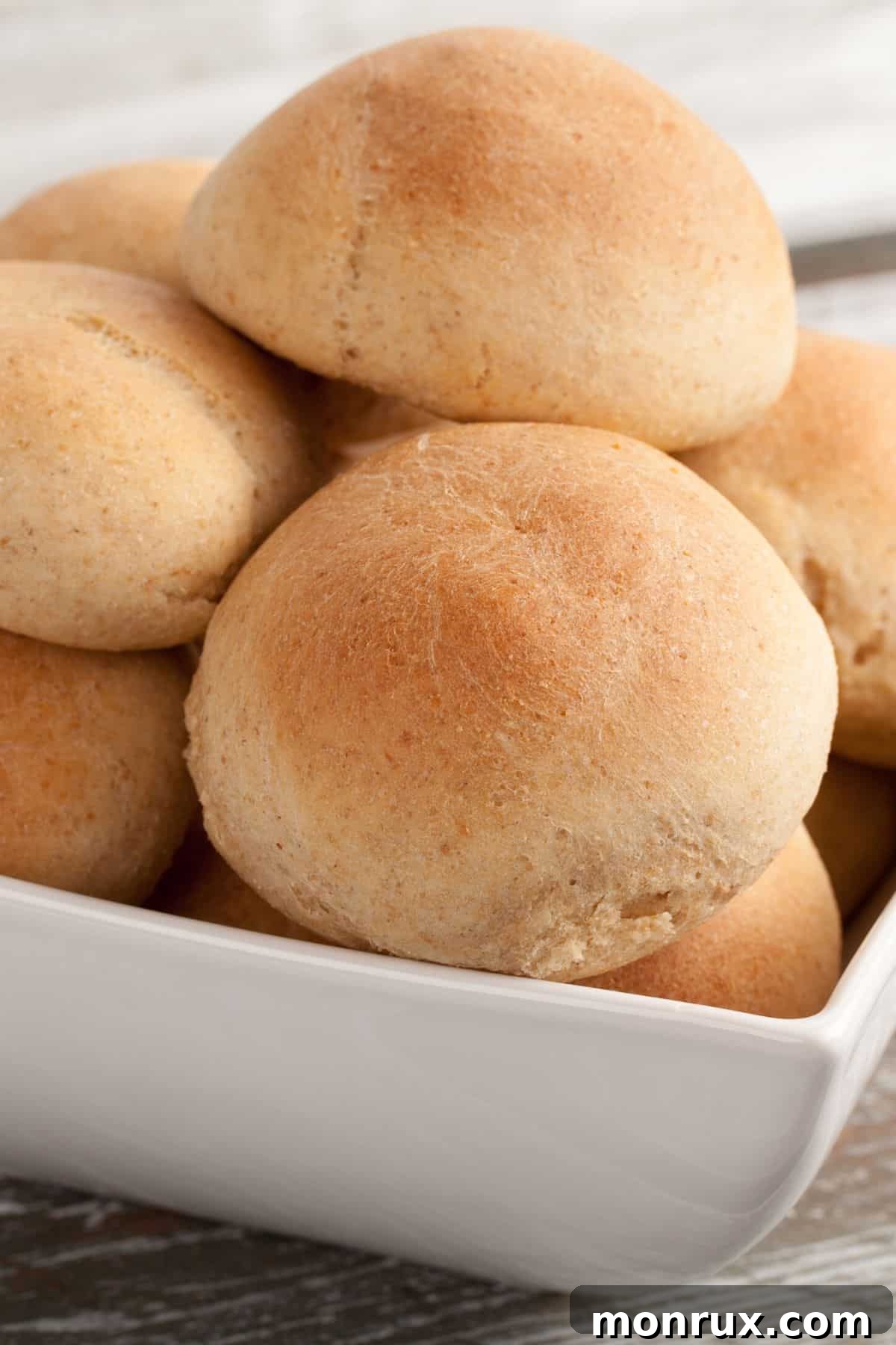 Baked gluten-free dairy-free dinner rolls in a bowl, golden brown and fluffy.