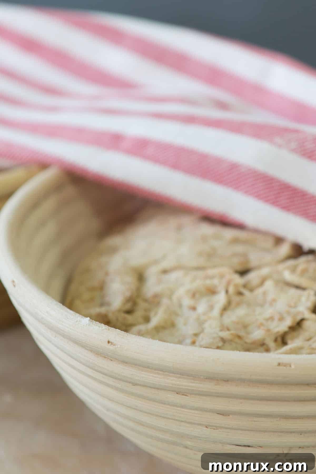 A ceramic bowl filled with shaggy, gluten-free bread dough, ready for its first rise.
