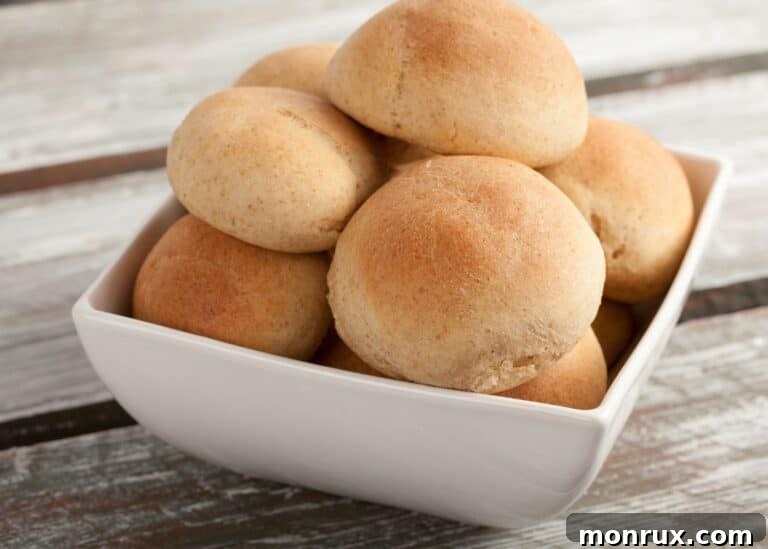 Gluten free and dairy free dinner rolls in a square dish, ready to be served.