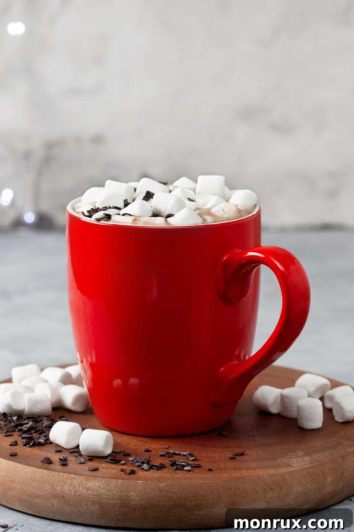 A red mug of hot chocolate topped with mini marshmallows.