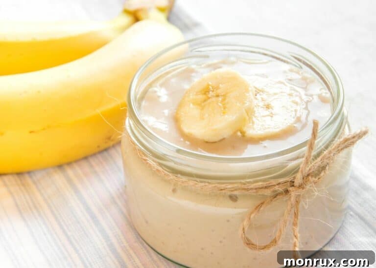 A squat jar filled with dairy-free banana pudding.