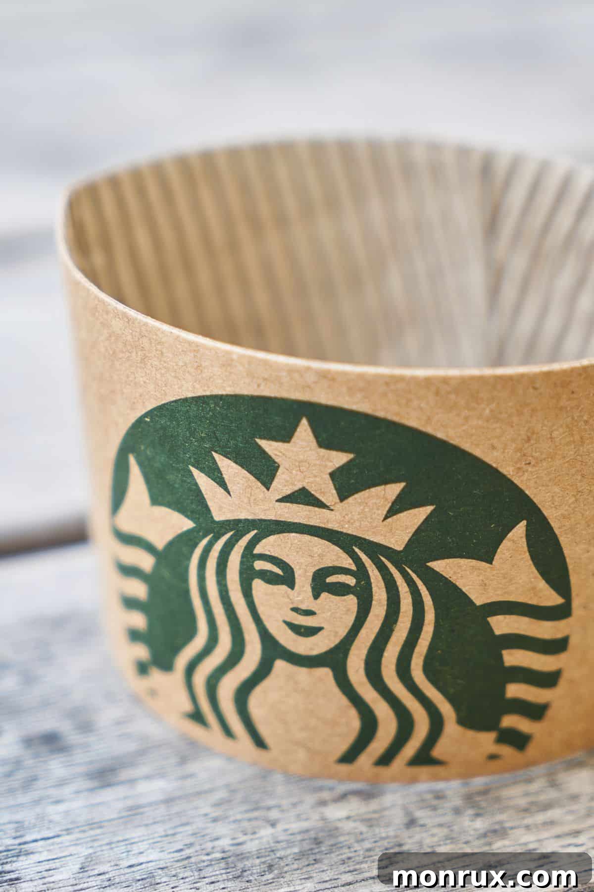 A Starbucks cup sleeve resting on a rustic wooden table, symbolizing a cozy moment with a favorite beverage.