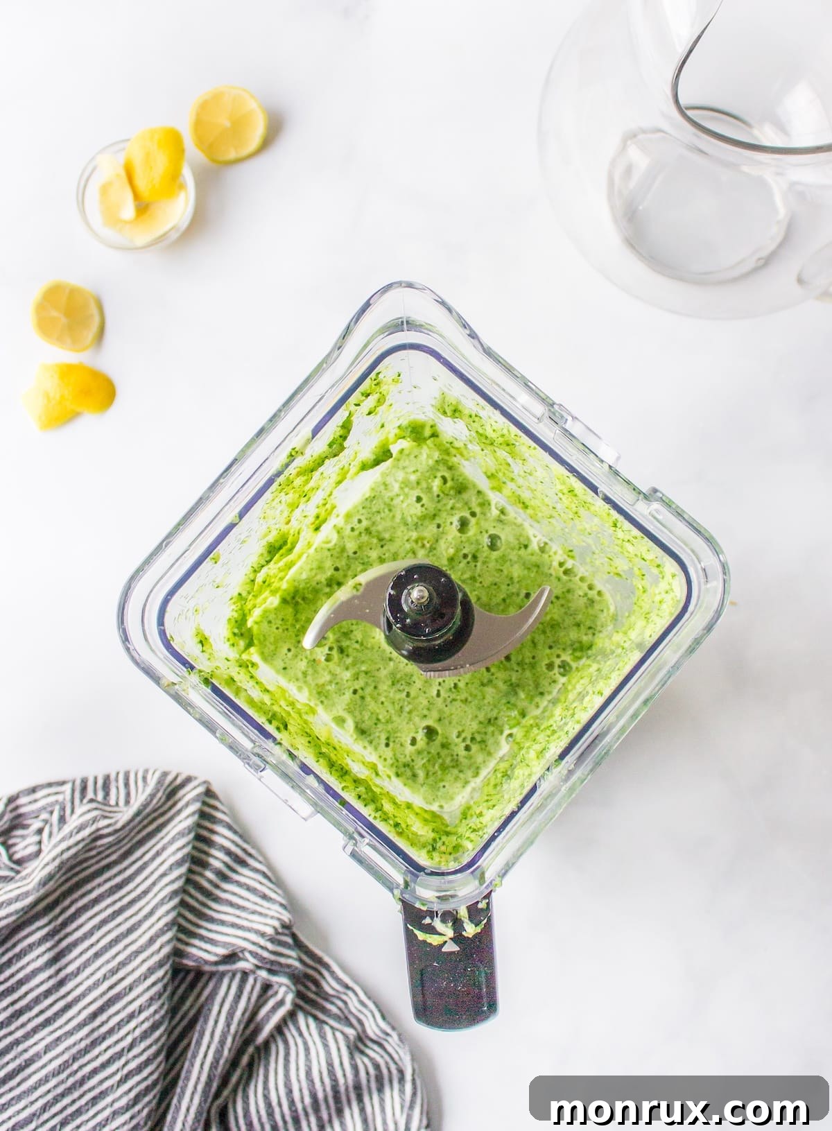 A high-speed blender actively blending green spinach juice ingredients, creating a vibrant green mixture.