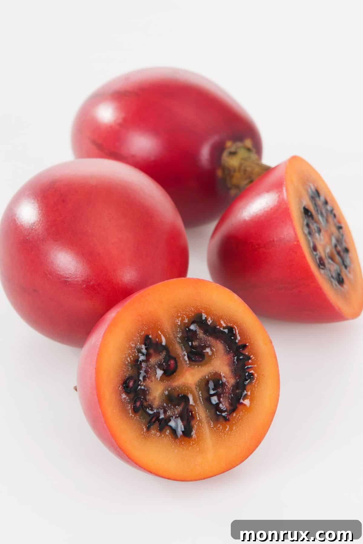 Several ripe tamarillos displayed on a clean white background.