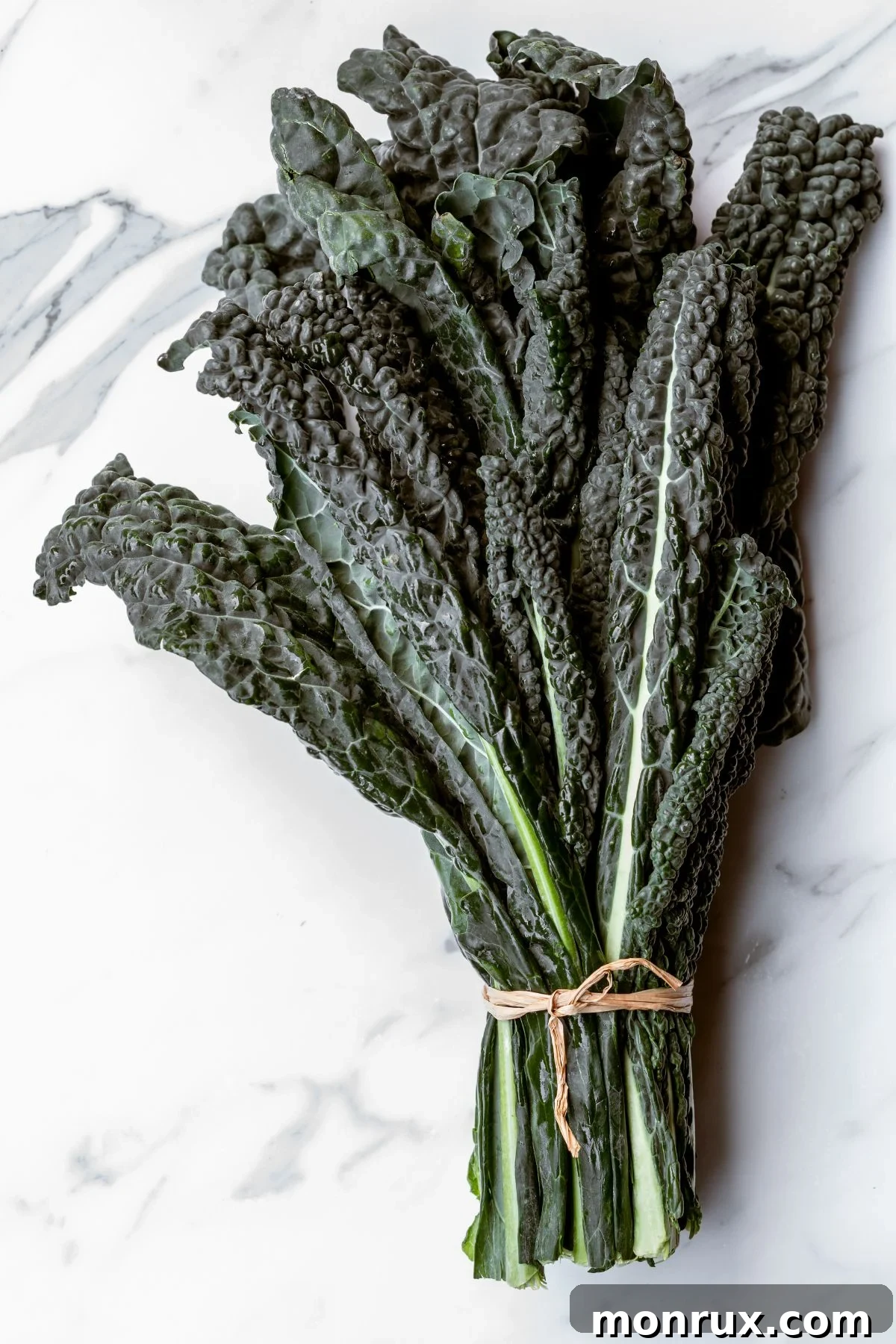 A fresh bunch of Tuscan kale, showing its characteristic dark, crinkled leaves.