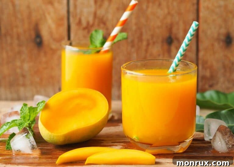 carrot mango juice in two glasses.