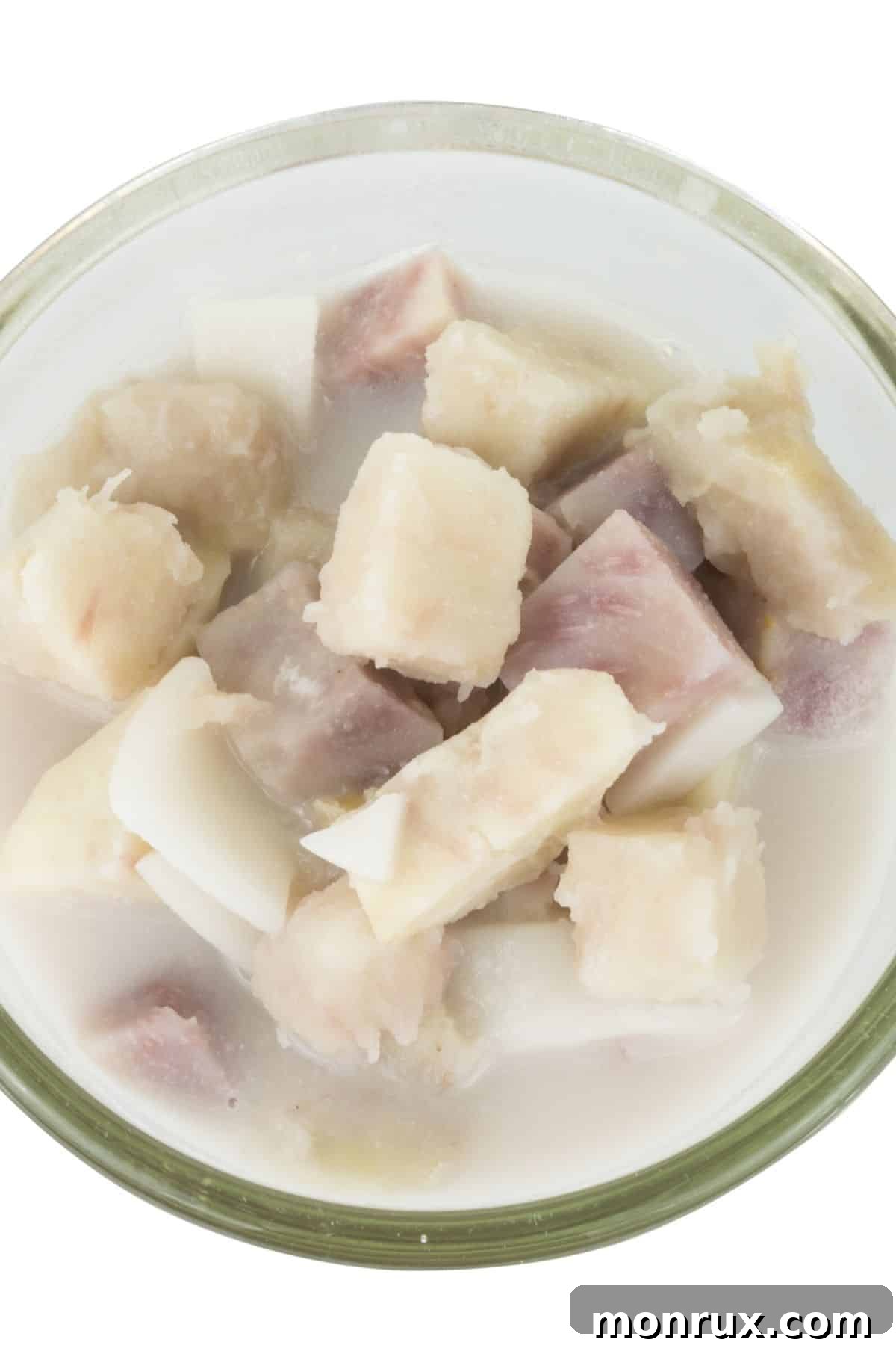 Fresh cut taro cubes in a glass bowl.