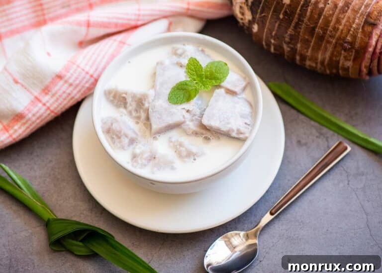 A white bowl of taro milk with mint leaves.