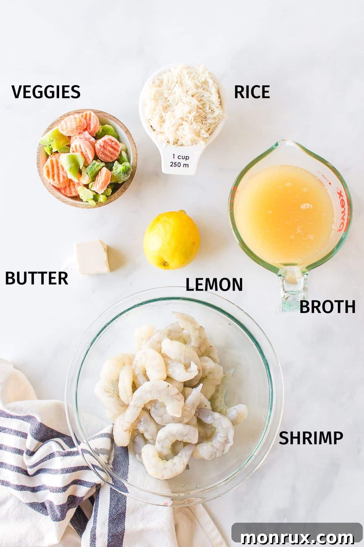 Small bowls containing ingredients for Instant Pot shrimp and rice: shrimp, basmati rice, mixed vegetables, broth, and lemon.