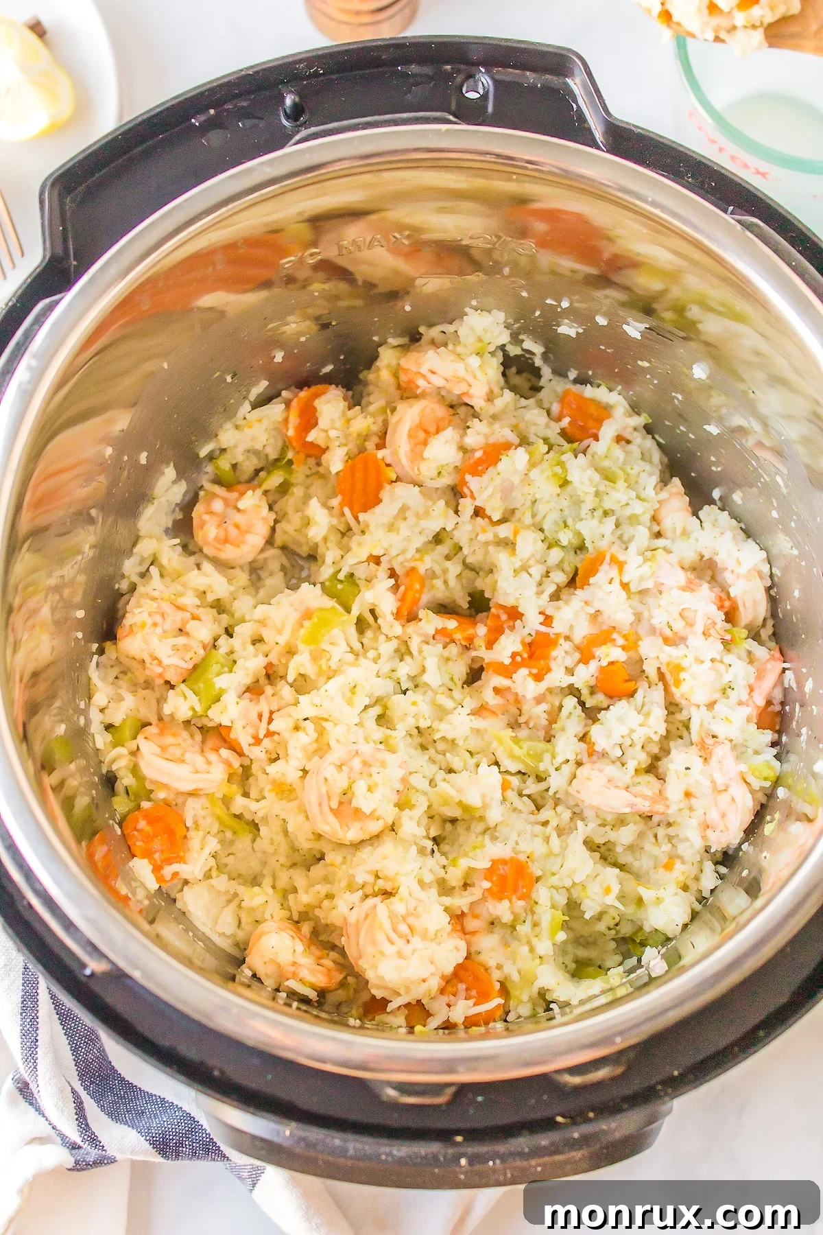 Cooked Instant Pot shrimp and rice, steaming inside the pot after quick release.