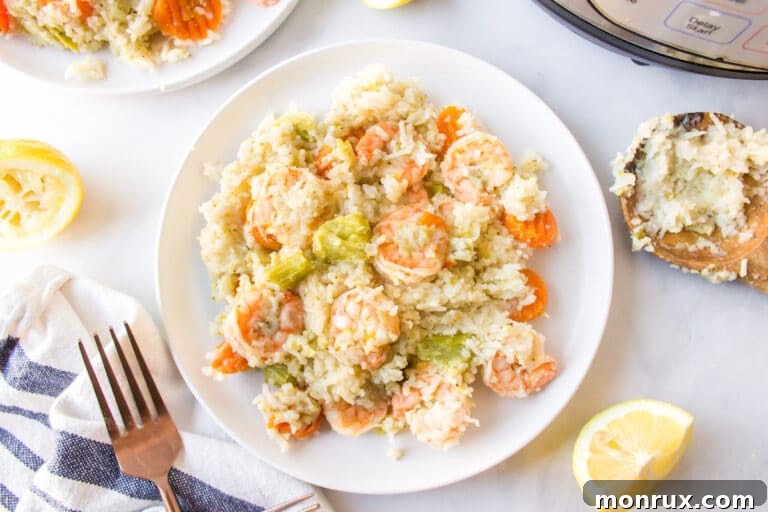 Instant Pot Rice and Shrimp on a white dinner plate, garnished with fresh herbs.
