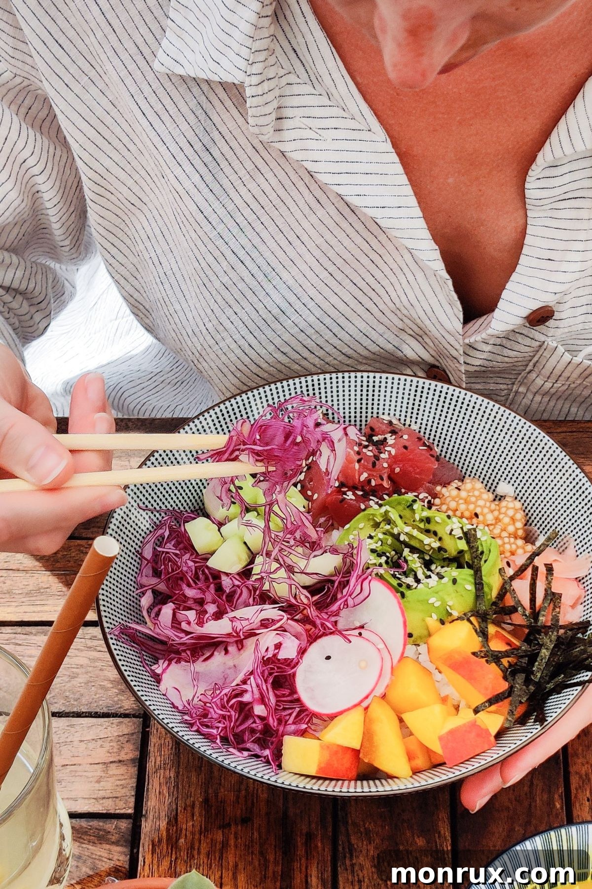 A woman mindfully eating a nutritious meal with chopsticks, symbolizing healthy and balanced food choices.
