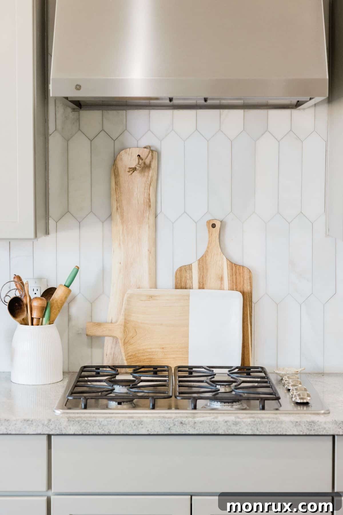 a sleek gas stovetop with multiple burners in a bright white kitchen.