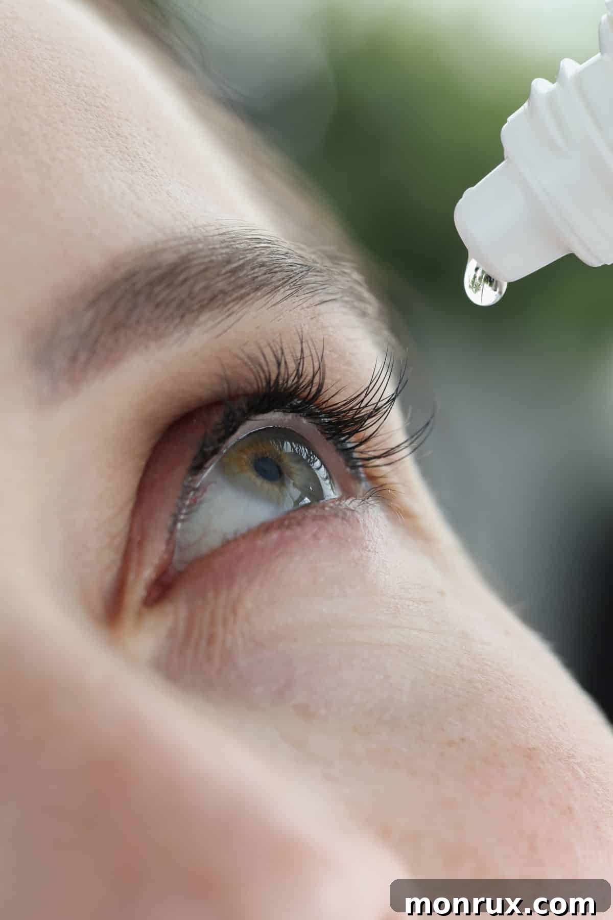 Woman putting drops in eye, illustrating relief from dry eye symptoms.