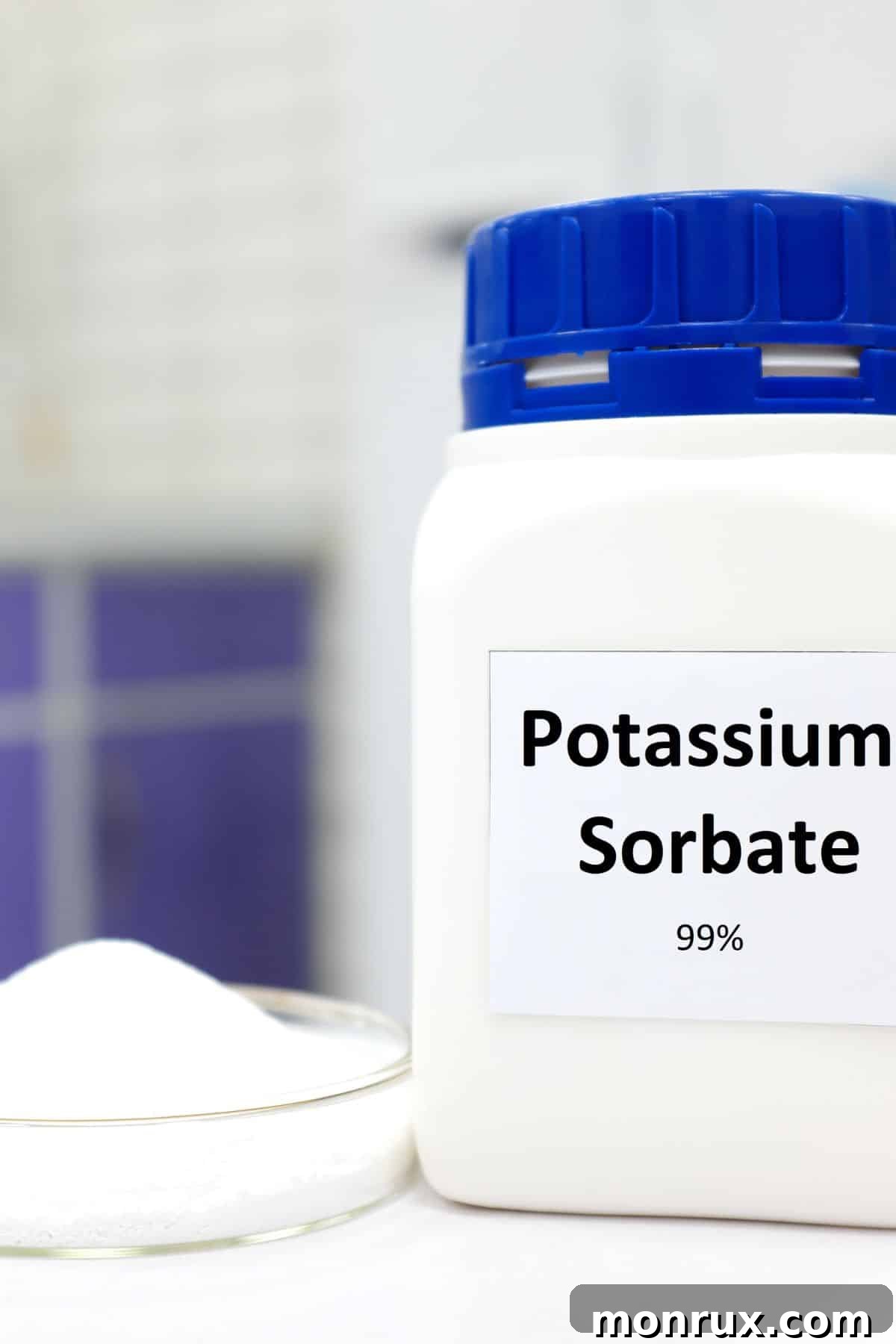 A bottle of potassium sorbate next to a beaker full of potassium sorbate crystals.
