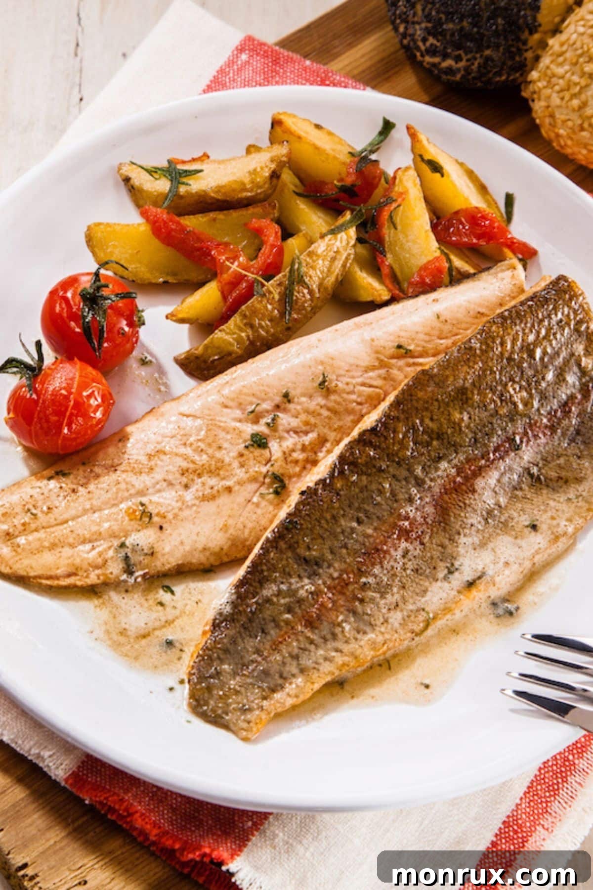 Cooked trout on a plate with fresh vegetables, ready to be served as a healthy meal.