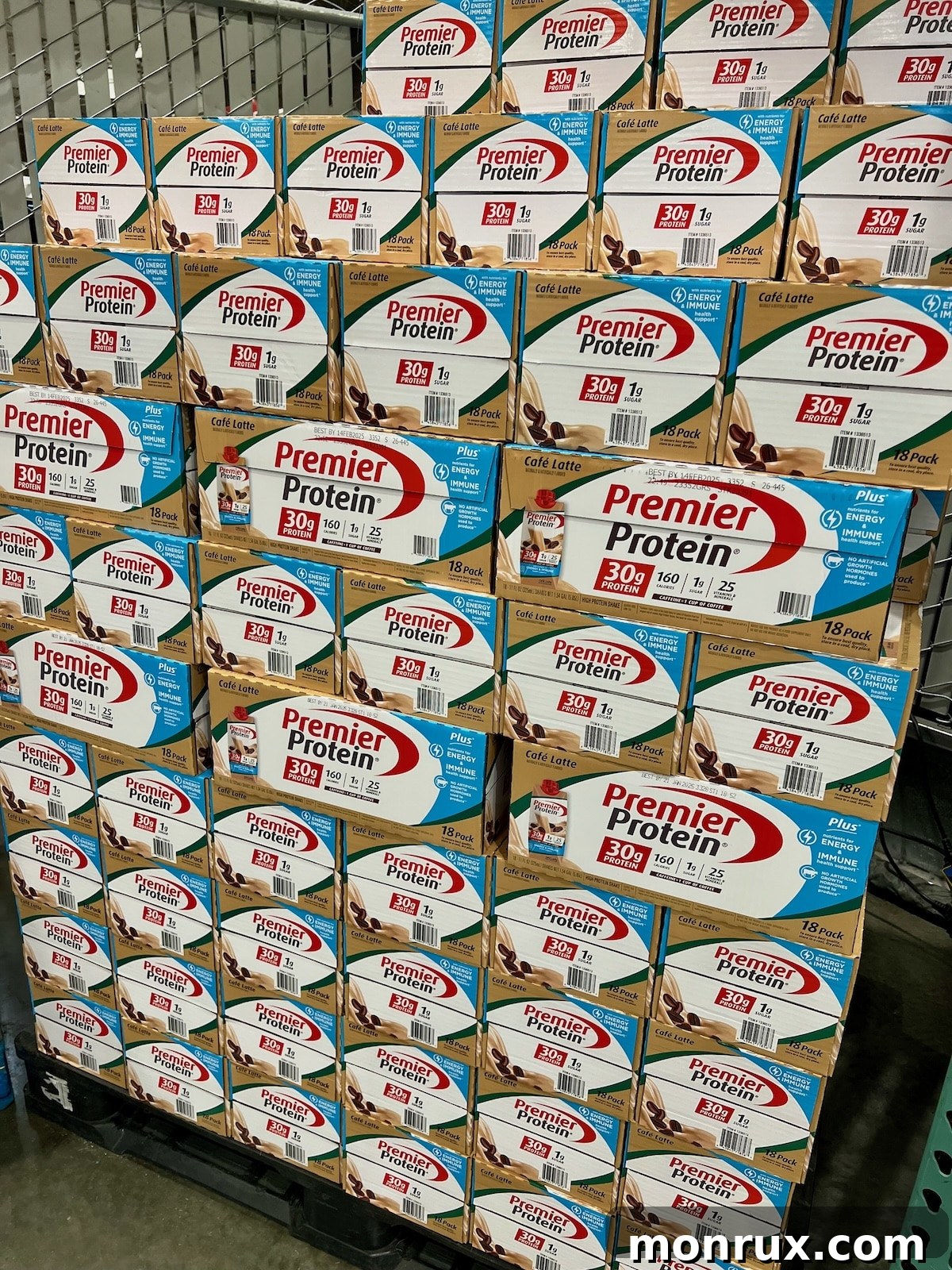 Premier Protein boxes stacked at Costco, illustrating the product's wide retail availability.