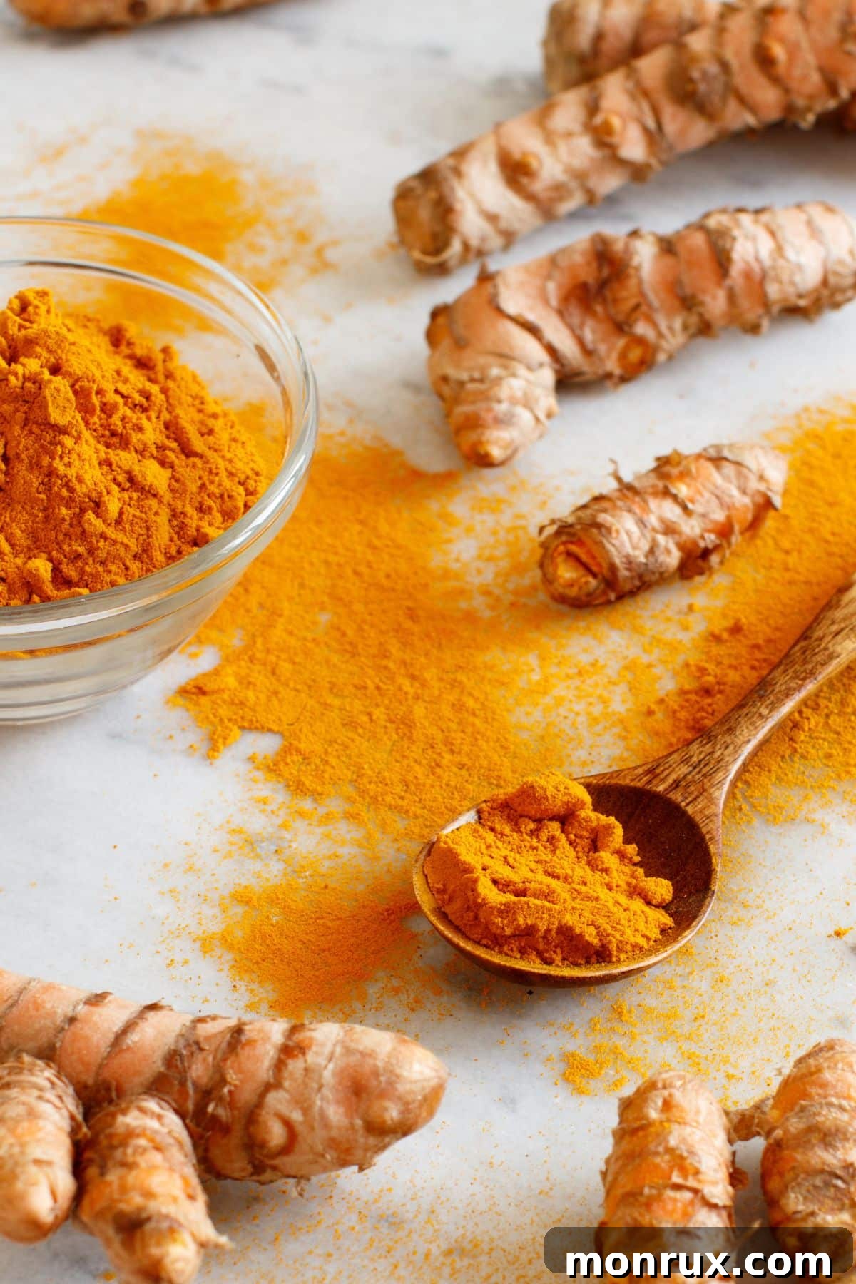 Vibrant turmeric powder in a wooden bowl with a matching wooden spoon, highlighting its use as a powerful natural spice.