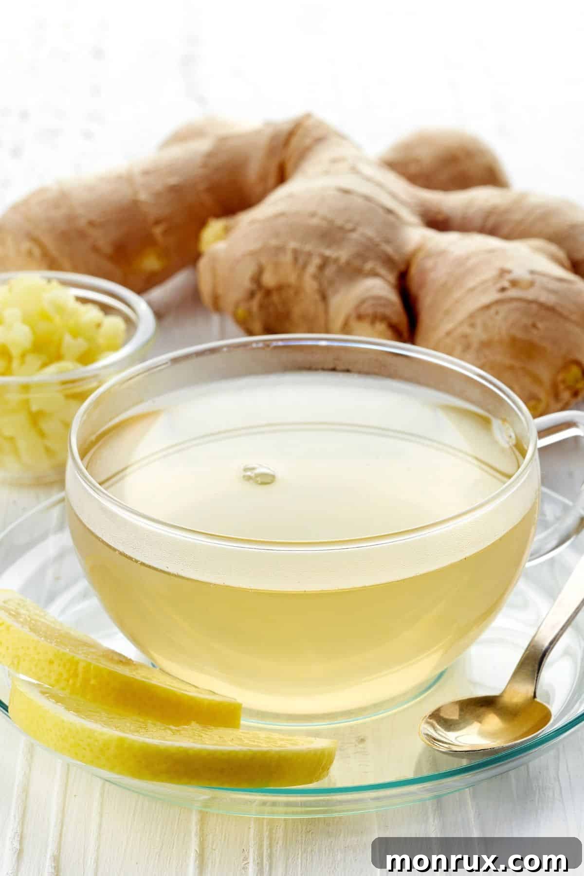 A warm cup of ginger tea with fresh ginger slices.